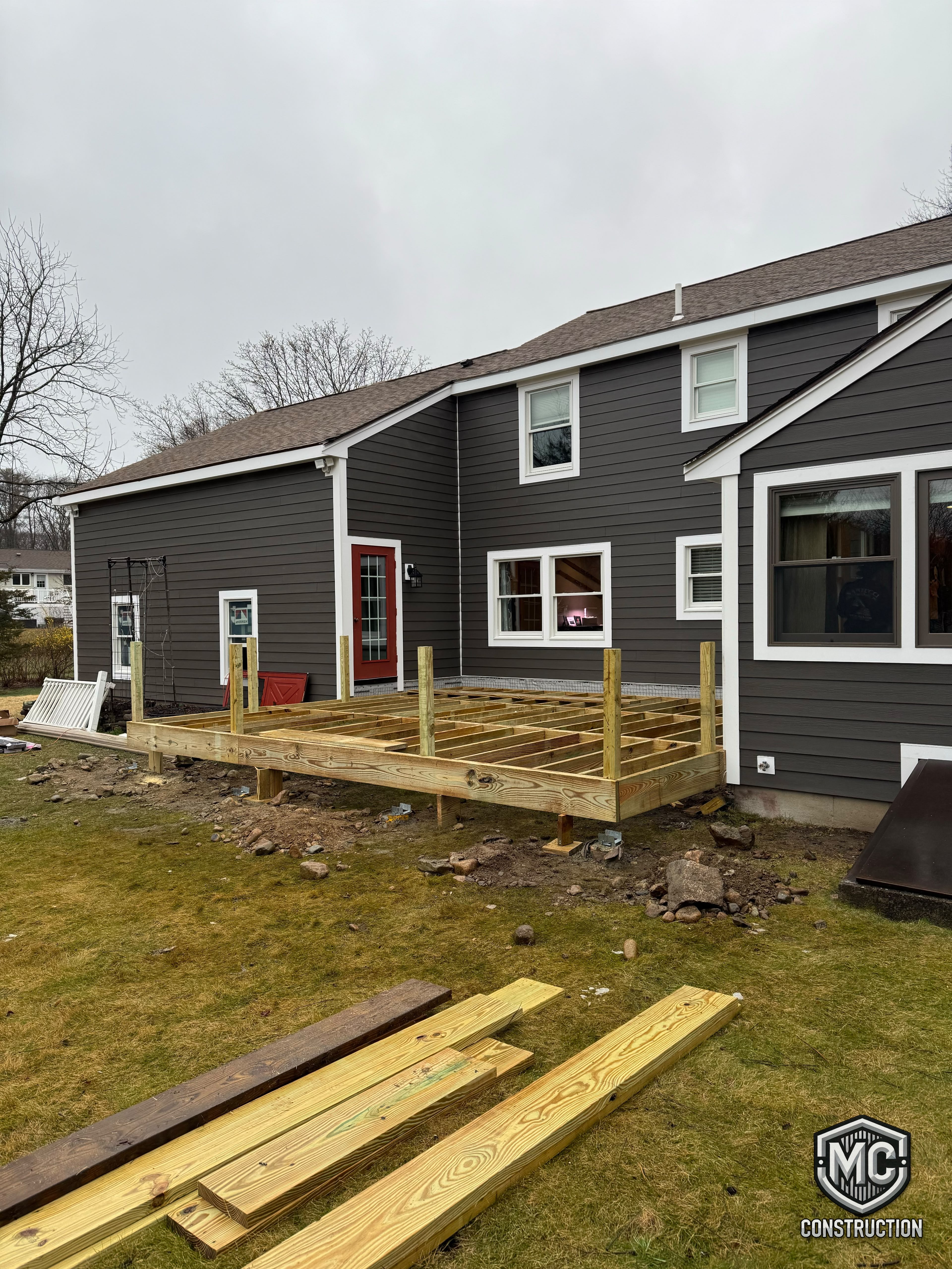 Pressure-treated deck framing under construction in Massachusetts